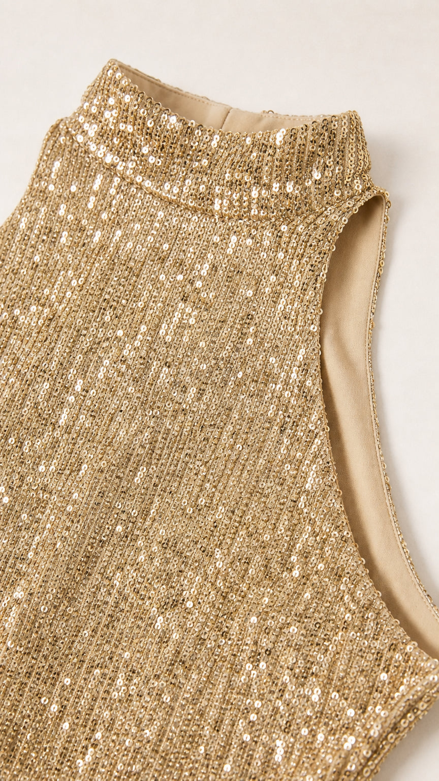 Close-up detail of high halter mock neckline and dense champagne gold sequins