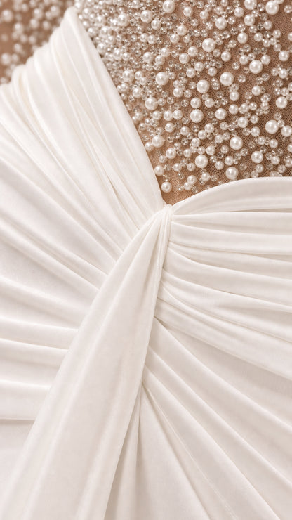 Close-up detail of pearl embellishments and ruched gathered waist on gown