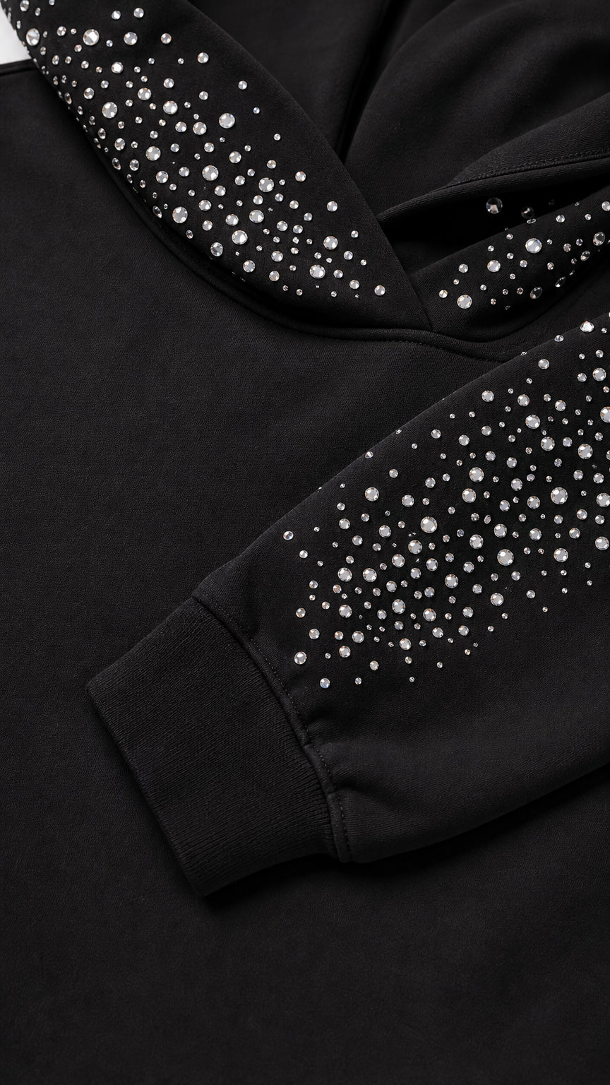 Close-up detail of rhinestone crystals on the hood and ribbed sleeve cuff