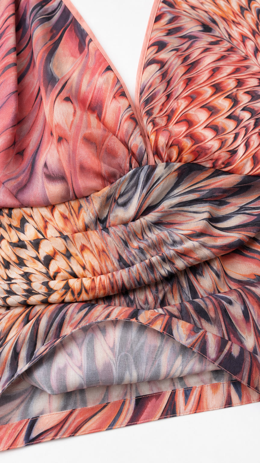 Close-up detail of draped neckline and ruched waist on feather print stretch fabric