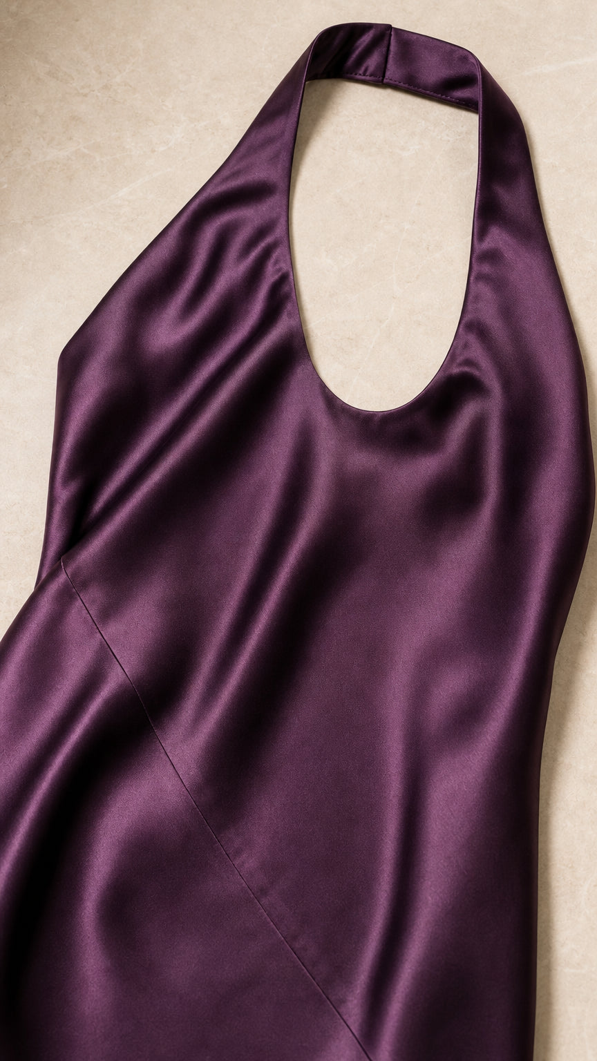 Close-up detail of halter neckline and satin fabric in plum purple