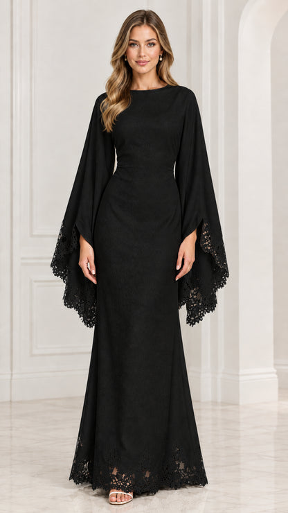 Front view of model wearing black cape sleeve evening maxi dress with lace trim