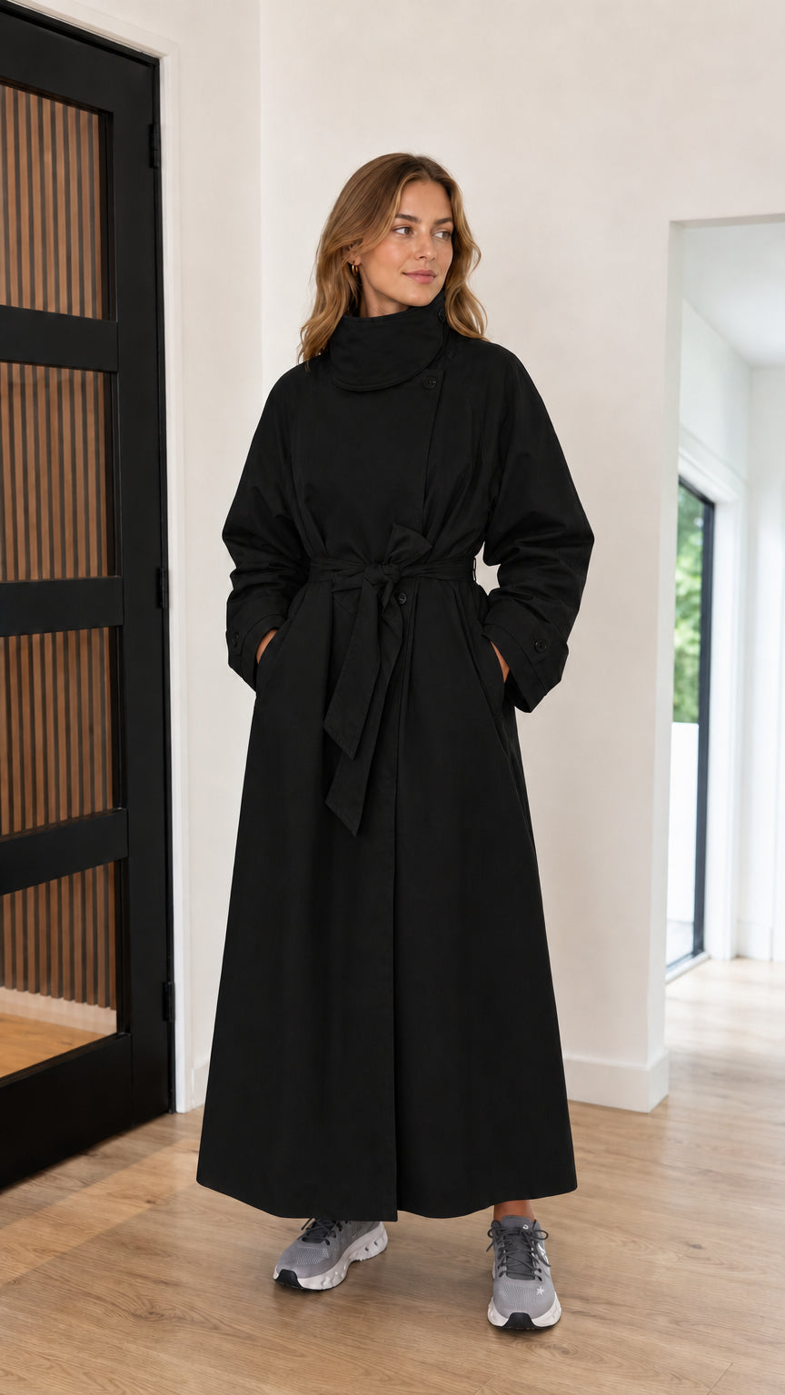 Front full-length view of black high neck maxi trench coat