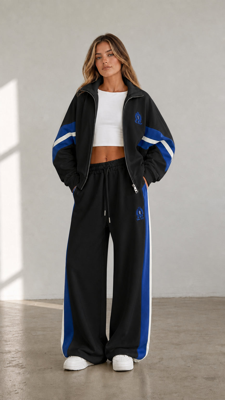 Black women's two-piece tracksuit set with blue contrast stripe details