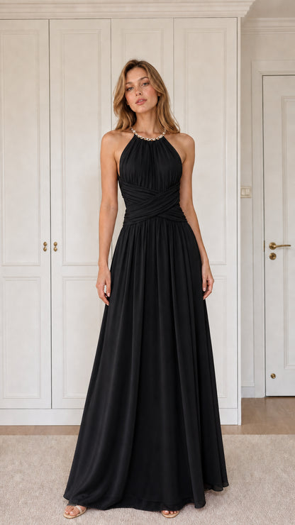 Front view of woman wearing black halter pleated chiffon maxi evening gown