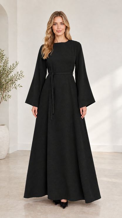 Full-length front view of woman wearing black long bell sleeve modest maxi dress