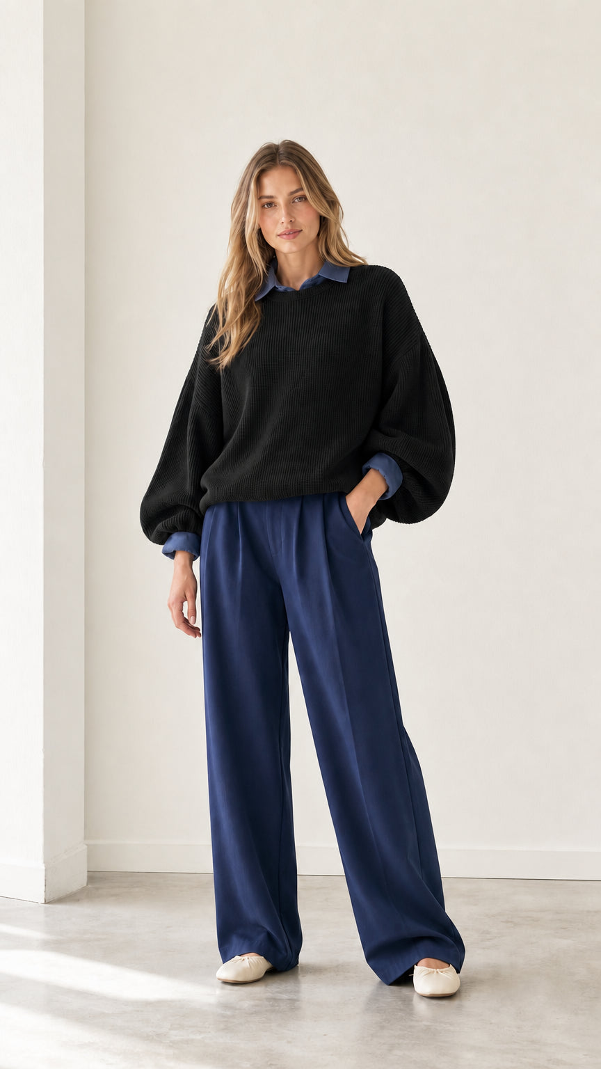 Model wearing black 2-in-1 ribbed sweater with blue collared trim