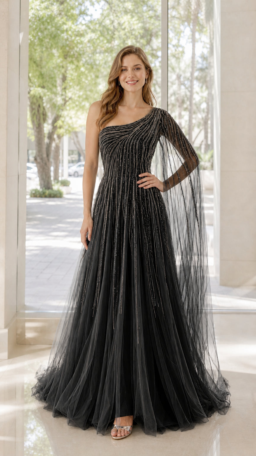 Front view of model wearing black one-shoulder beaded tulle evening dress
