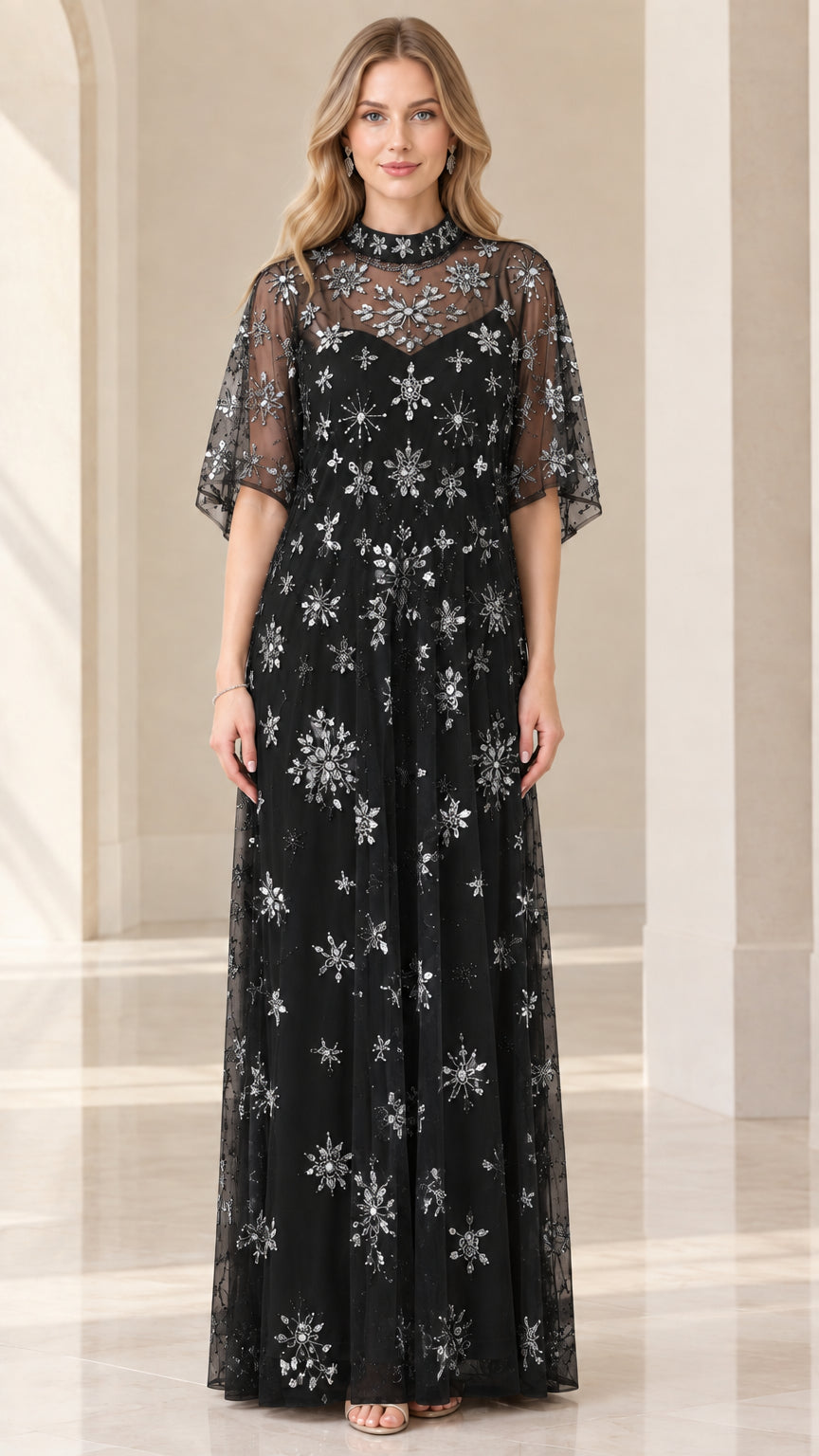 Front view of woman wearing black starburst beaded evening gown with flutter sleeves