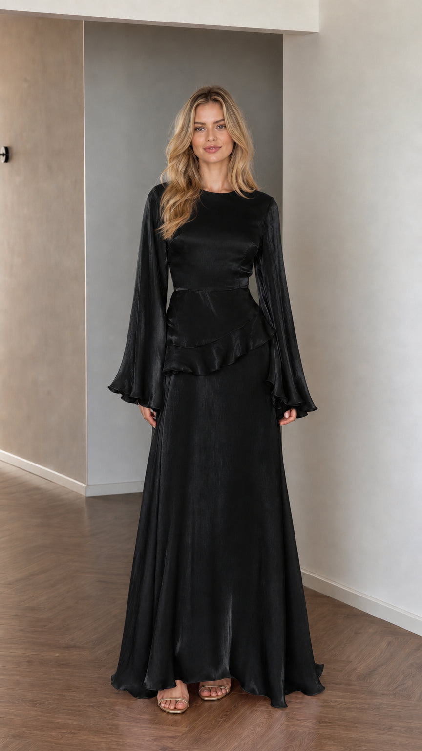 Front view of model wearing black satin long sleeve maxi dress