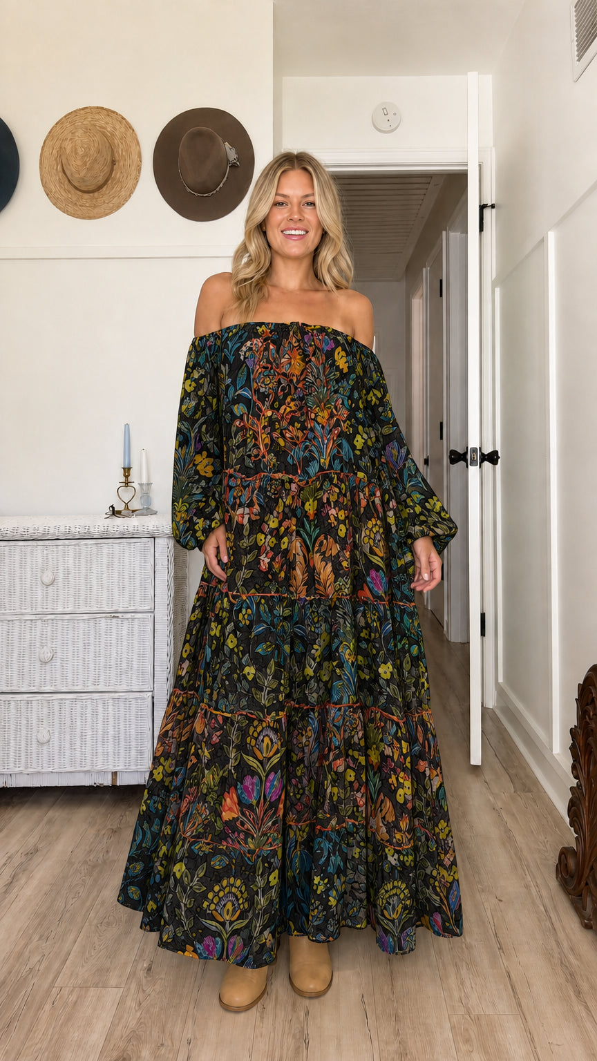 Model wearing black floral off-the-shoulder tiered maxi dress