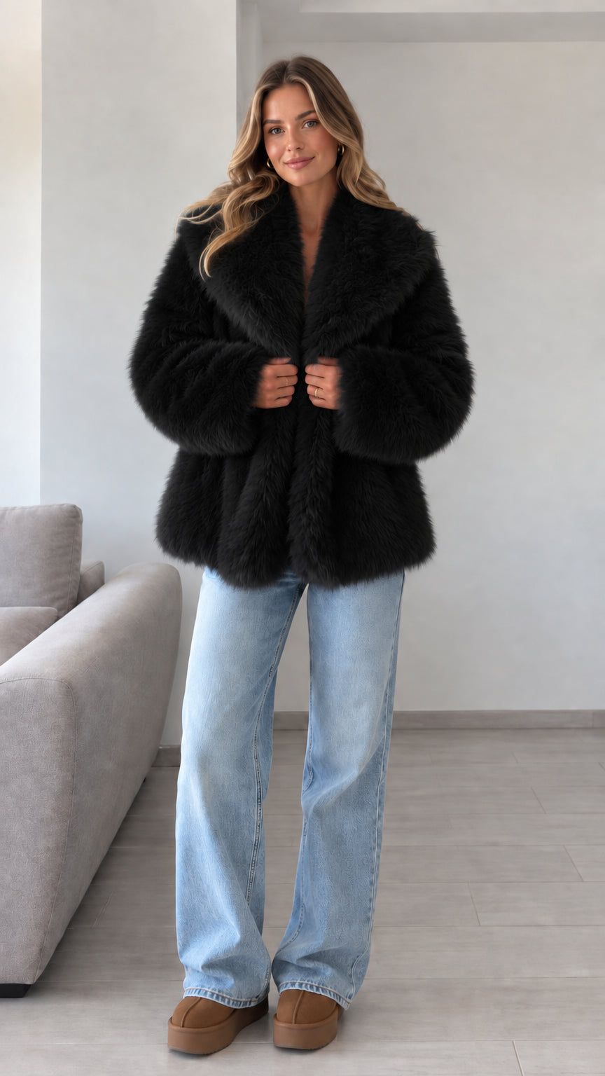Front view of model wearing black plush faux fur lapel jacket