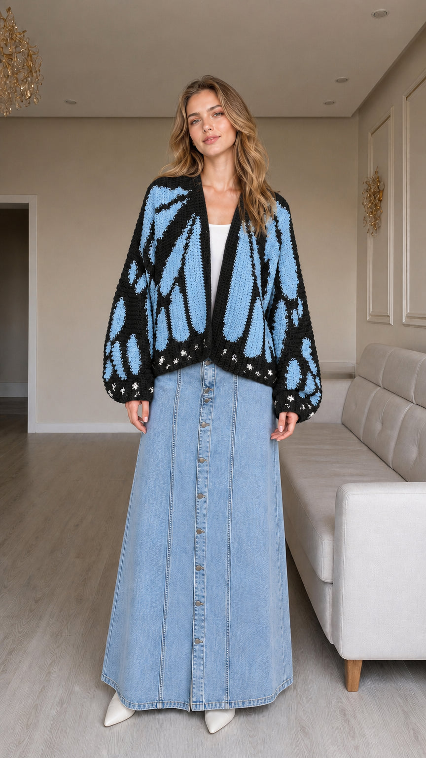 Model wearing black and blue butterfly graphic knit cardigan