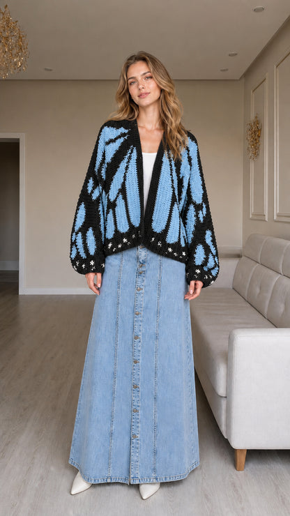 Model wearing black and blue butterfly graphic knit cardigan