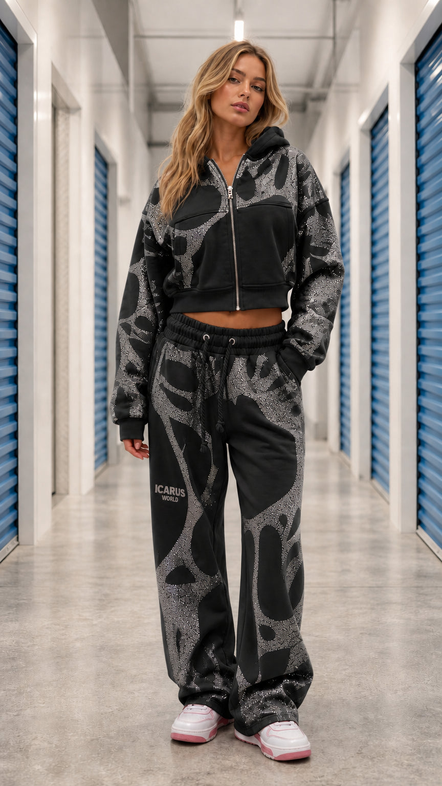 Front view of model wearing Black glitter graphic cropped zip hoodie and wide leg sweatpants set