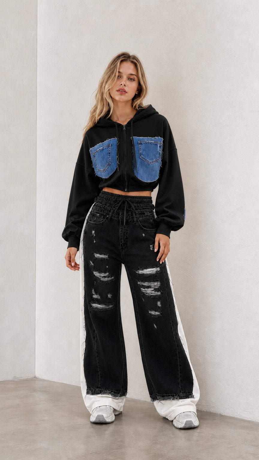 Model wearing black cropped zip hoodie and black distressed wide leg pants set