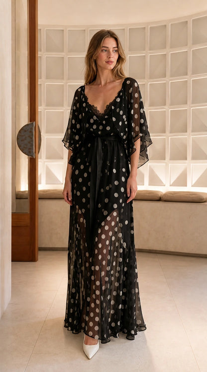 Model wearing black polka dot lace trim maxi dress with flutter sleeves