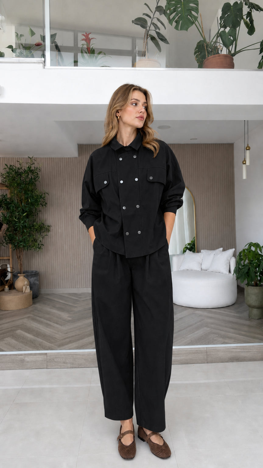 Model wearing black double-breasted shirt and wide-leg pants two-piece set