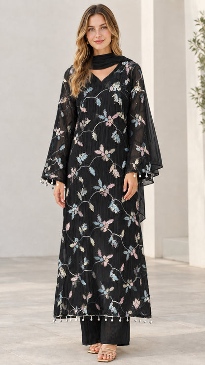 Model wearing black 3-piece embroidered kurta set with matching scarf