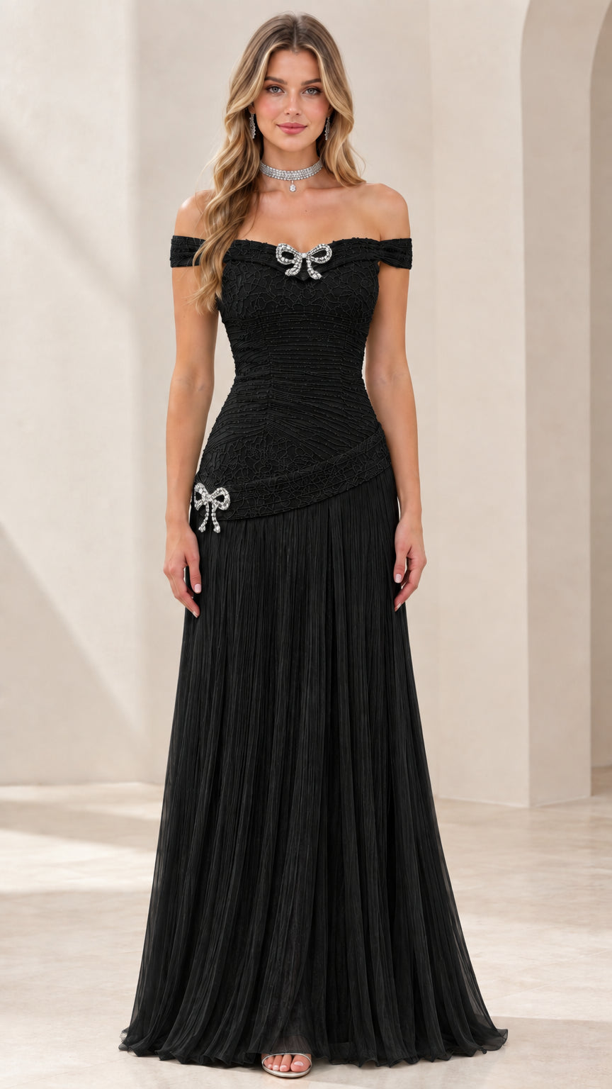 Full-length view of black off-the-shoulder pleated evening gown