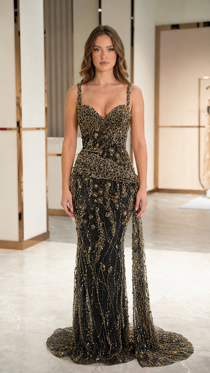 Front view of model wearing black and gold embellished sequin mermaid evening gown