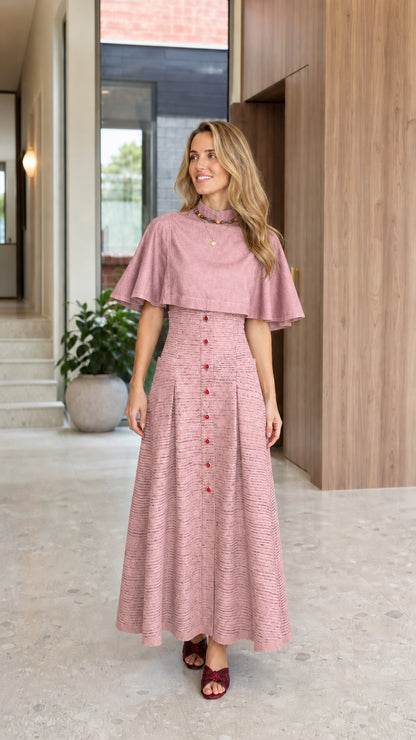 Full-length front view of woman wearing Dusty Rose capelet mock neck pleated maxi dress