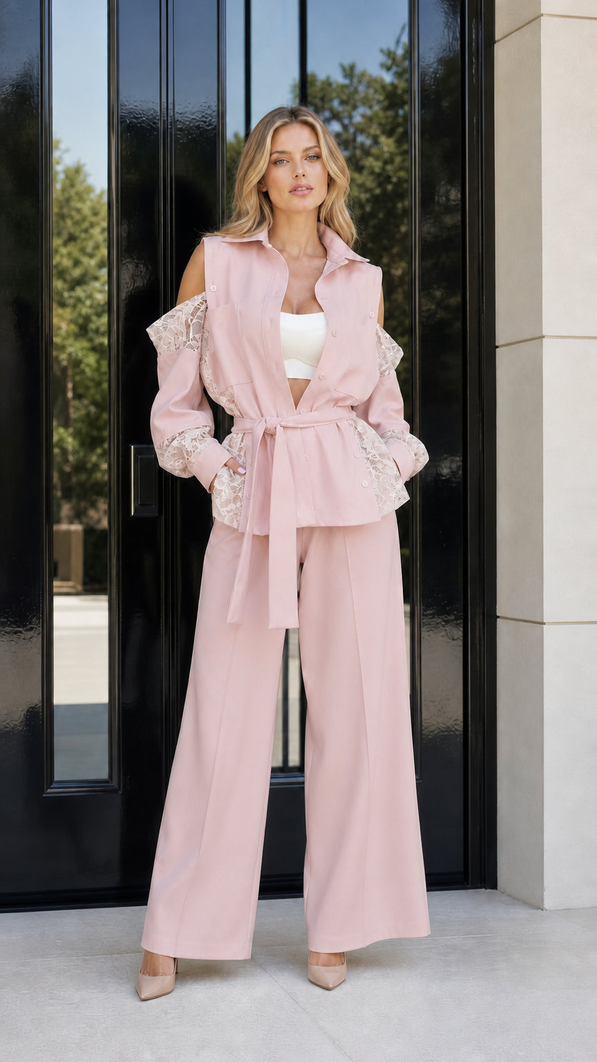 Model wearing blush pink cold shoulder lace blazer and wide leg pants set
