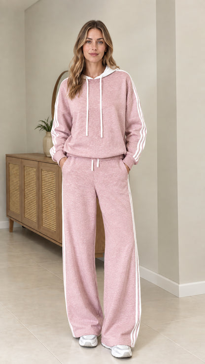 Model wearing Dusty Pink two-piece tracksuit set with white side stripes