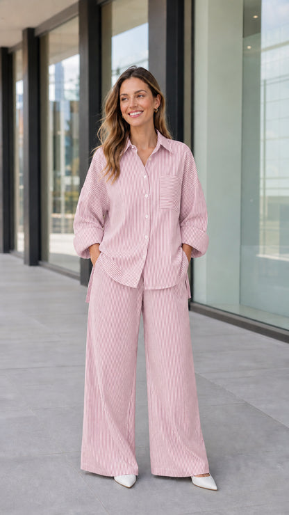 Full-length view of woman wearing light pink striped two-piece shirt and pants set