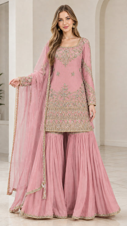 Full-length view of woman wearing Blush Pink embroidered sharara suit set with dupatta