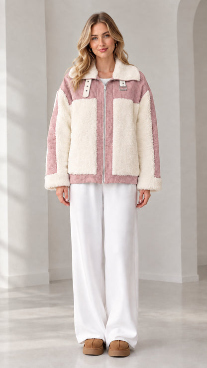 Front view of woman wearing dusty pink and cream colorblock sherpa fleece zip jacket
