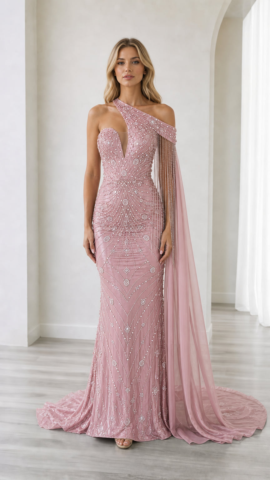 Front full-length view of the blush pink sequined one-shoulder evening gown with cape drape
