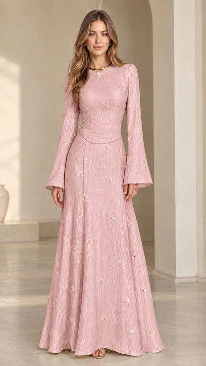 Front view of model wearing blush pink floral jacquard bell sleeve maxi dress