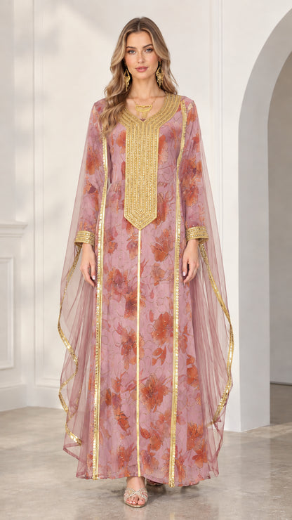 Model wearing dusty pink floral kaftan dress with gold embroidery and sheer side cape