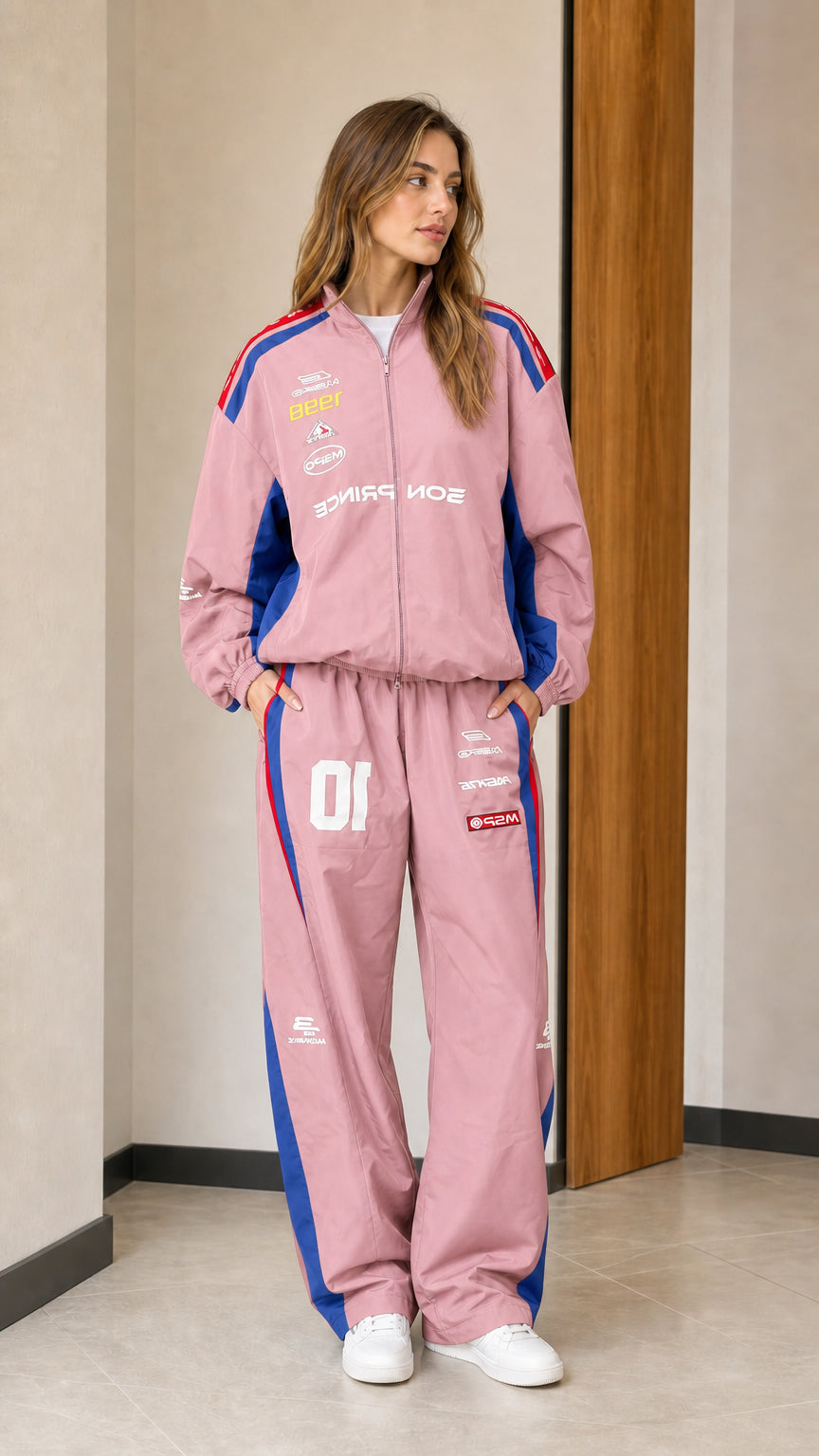 Front view of woman wearing dusty pink colorblock racing two-piece tracksuit set
