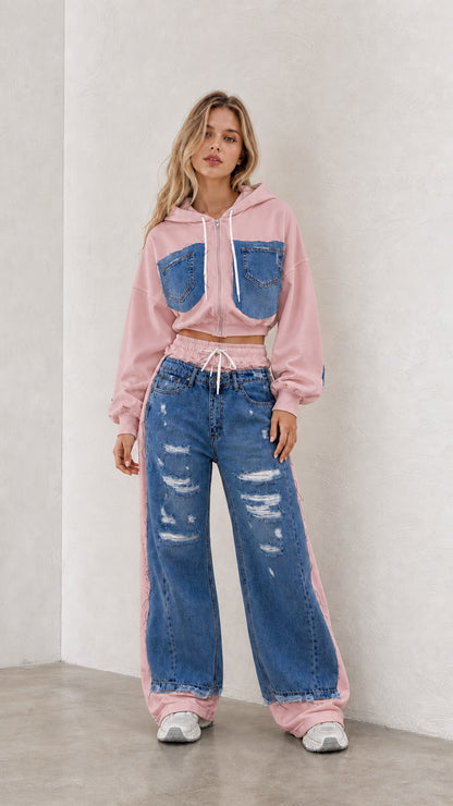 Model wearing pink cropped zip hoodie and blue denim spliced wide leg pants set