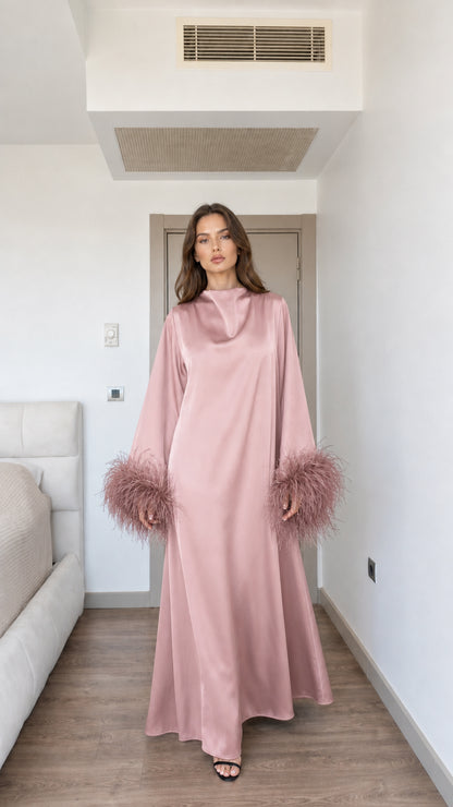 Model wearing dusty pink satin maxi dress with matching feather cuffs