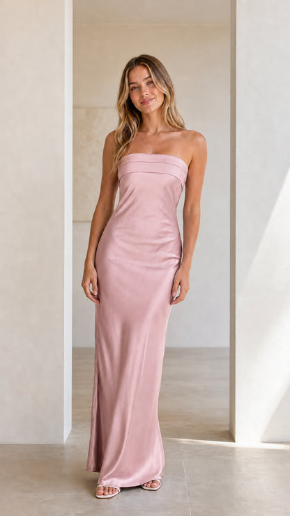 Front view of model wearing a blush pink strapless satin maxi dress