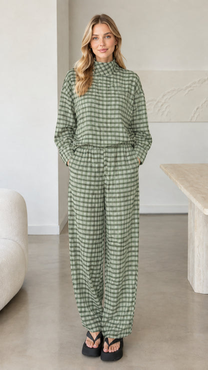 Front view of woman wearing sage green plaid mock neck top and wide leg pants set