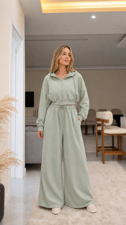 Model wearing sage green cropped zip hoodie and wide-leg lounge pants set