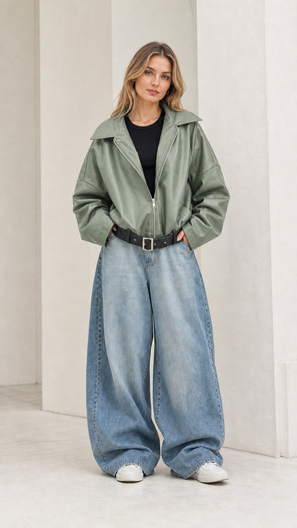 Full front view of model wearing sage green oversized faux leather jacket