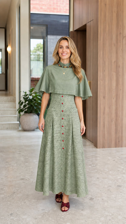Full-length front view of woman wearing Sage Green capelet mock neck pleated maxi dress