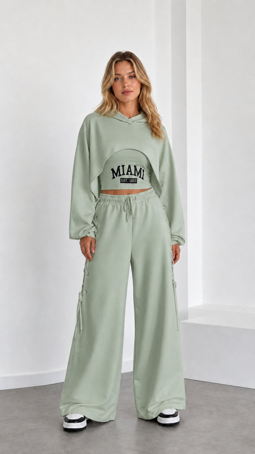 Model wearing sage green 3-piece cropped hoodie and wide leg pants set