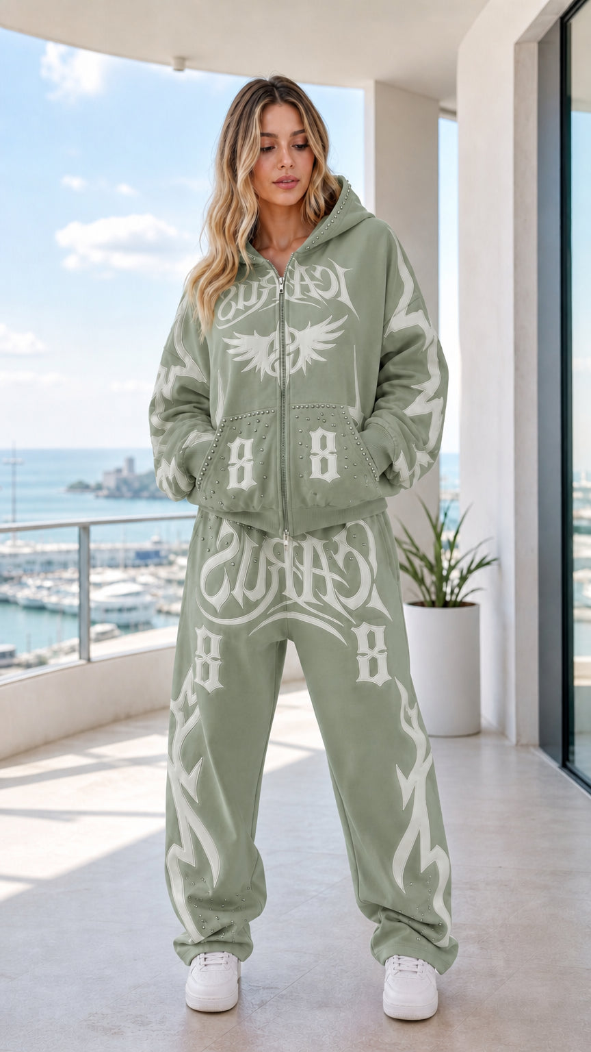 Full body front view of sage green graphic zip-up hoodie and sweatpants set