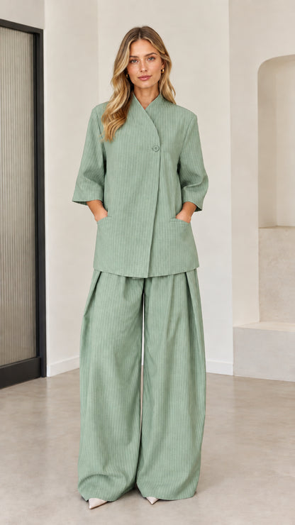 Sage green pinstriped tailored two-piece set with crossover collar and wide trousers