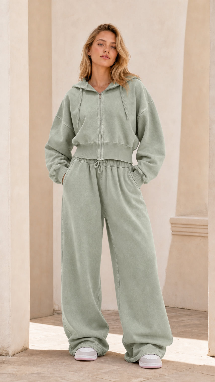 Full front view of model wearing sage green cropped zip hoodie and wide leg sweatpants set
