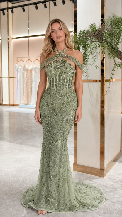 Model wearing sage green beaded halter mermaid formal gown