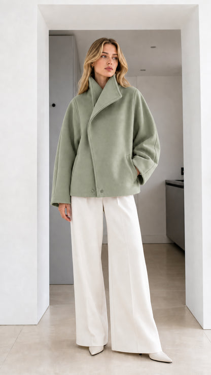 Full-length view of model wearing sage green asymmetrical short coat