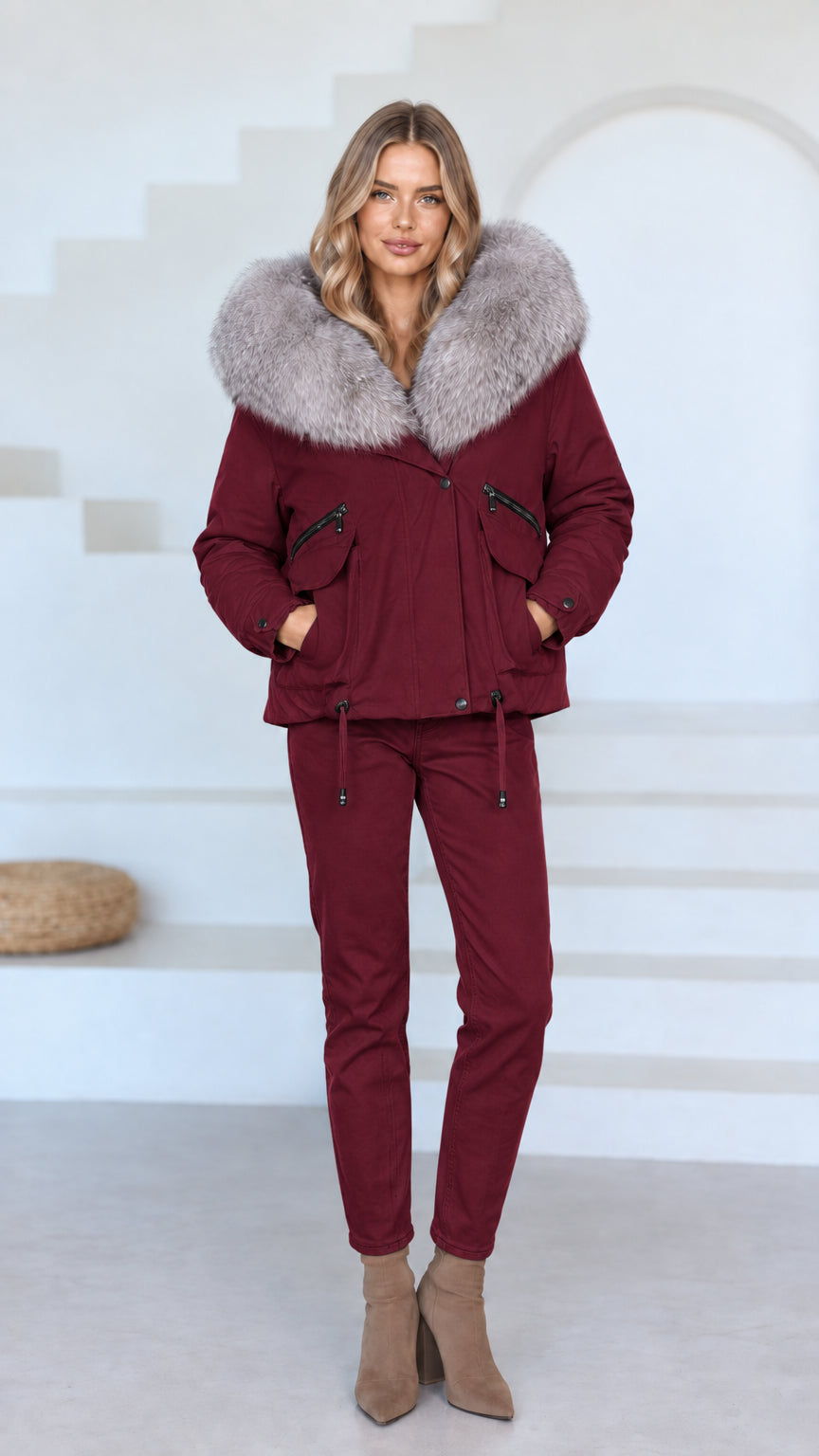 Front view of model wearing burgundy red faux fur hooded jacket and matching burgundy pants