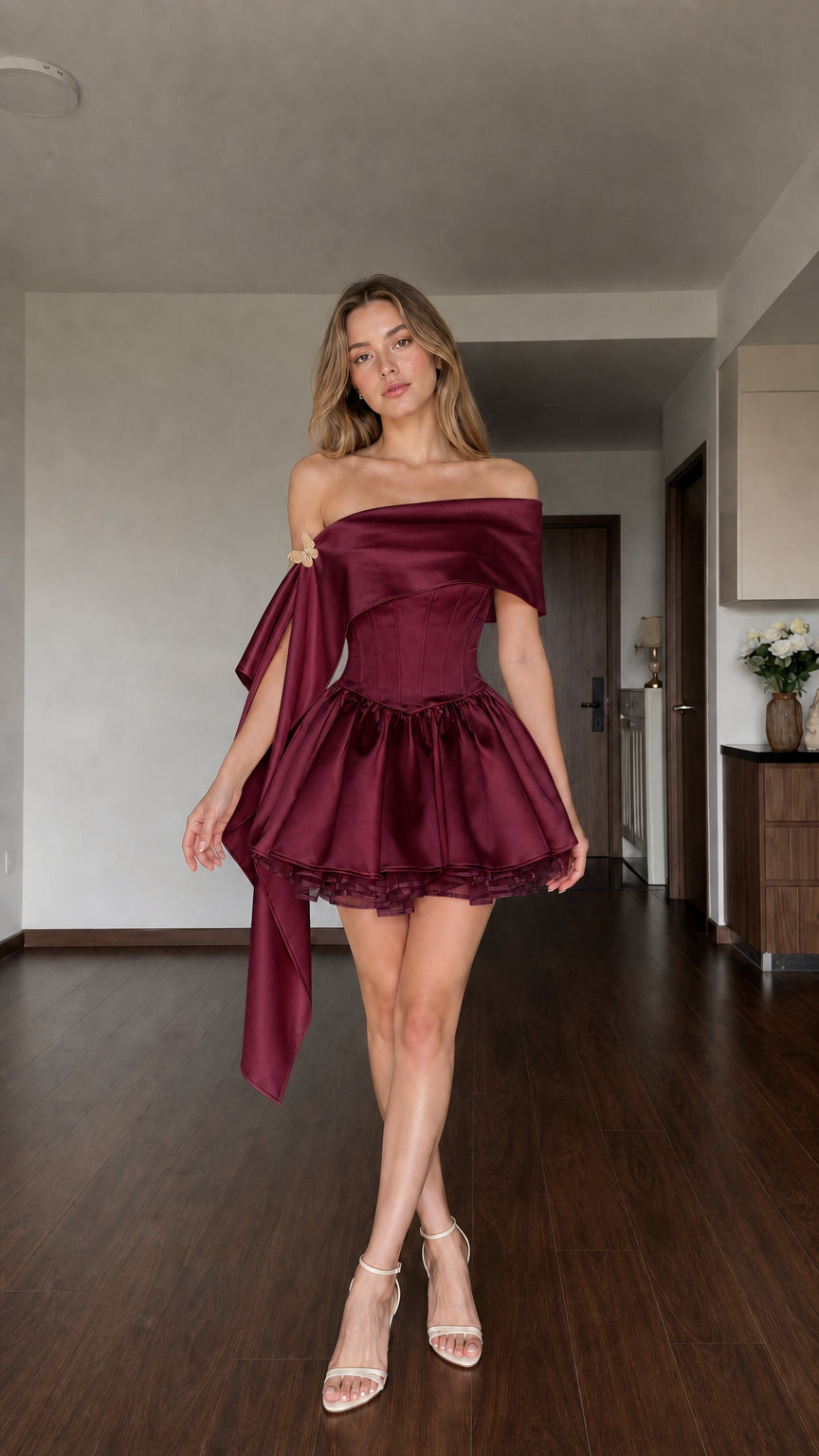 Woman wearing Burgundy wine satin off-the-shoulder corset mini dress with elegant drape